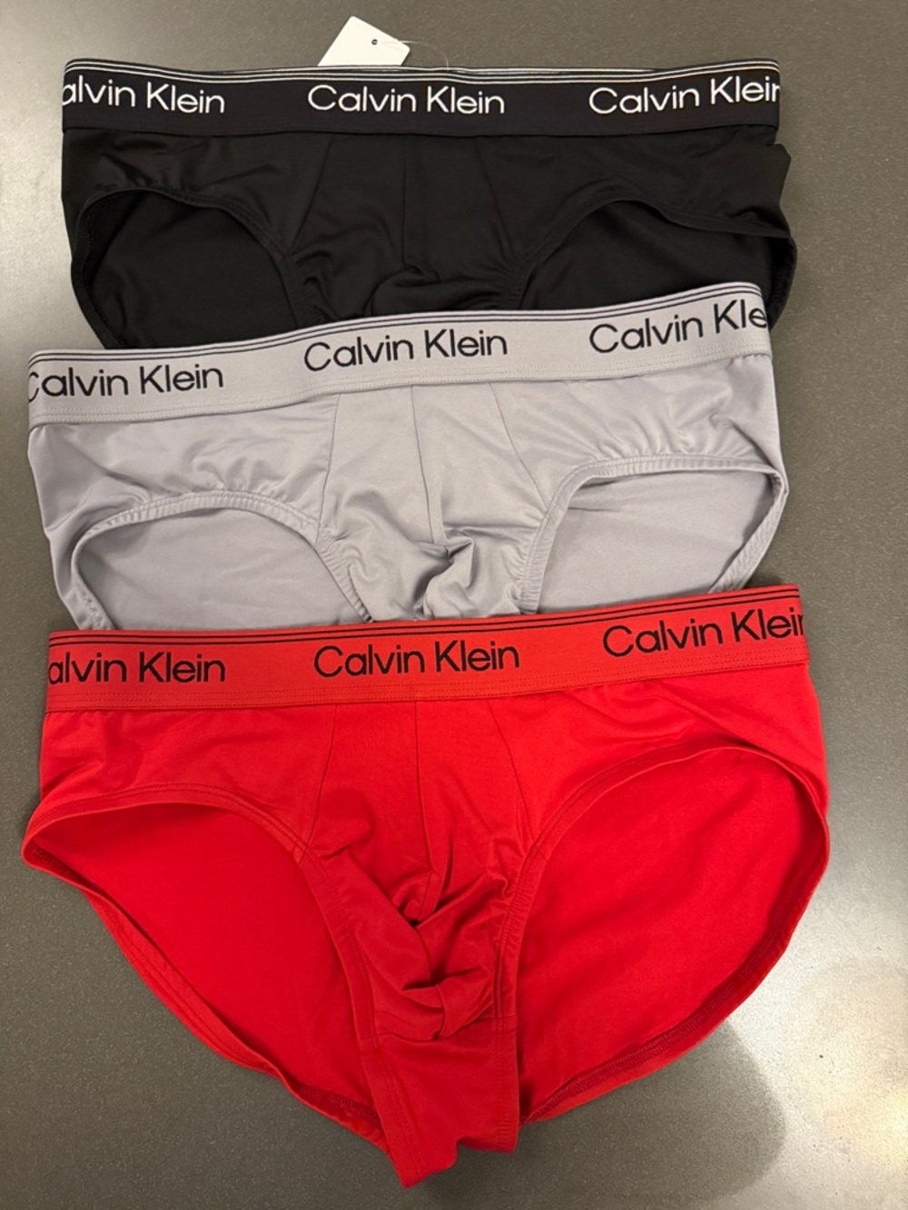 New Calvin Klein Hip Briefs Trio in Black, Gray, Red. Microfiber